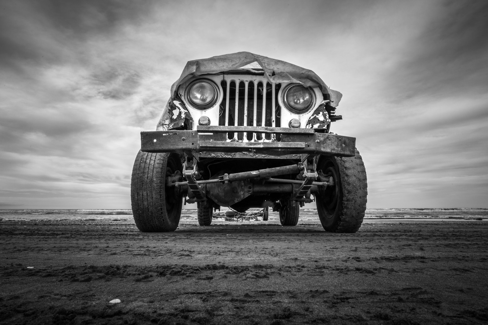 a black and white photo of an old jeep