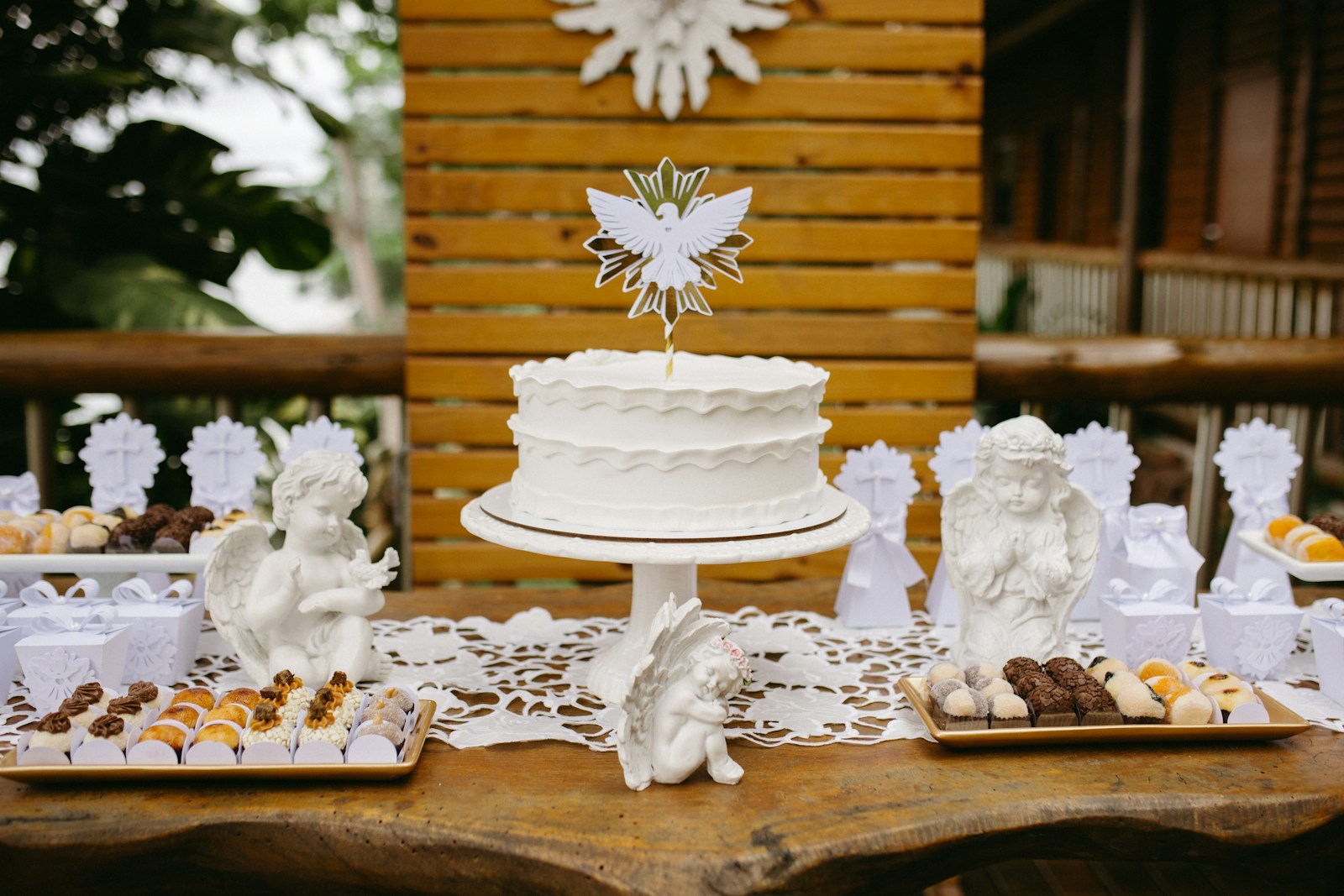 A table topped with a white cake covered in frosting